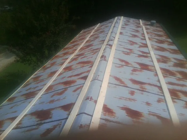 Rusted metal roof panels with new wood purlins before replacement — Storm Damage Roof Repair in Little River by Roofing Brothers